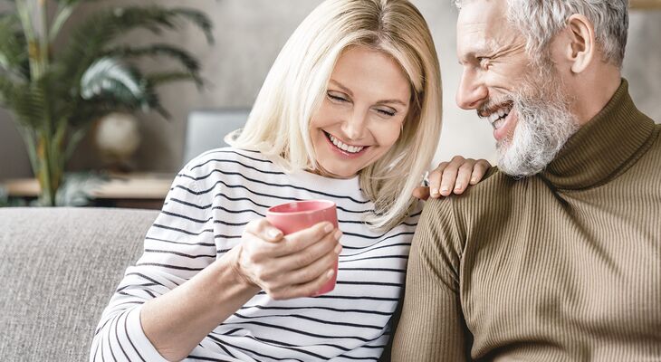 Glückliches Best-Age Paar sitzt auf Couch