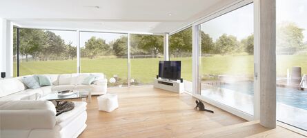 Moderner Wohnraum mit UNILUX Ganzglasecke OpenView und UNILUX Hebe-Schiebe Element