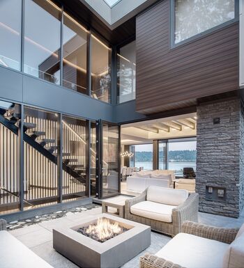 Blick von Terrasse auf modernes Haus mit großen UNILUX Aluminiumfenstern und UNILUX Faltschiebetür Exterior